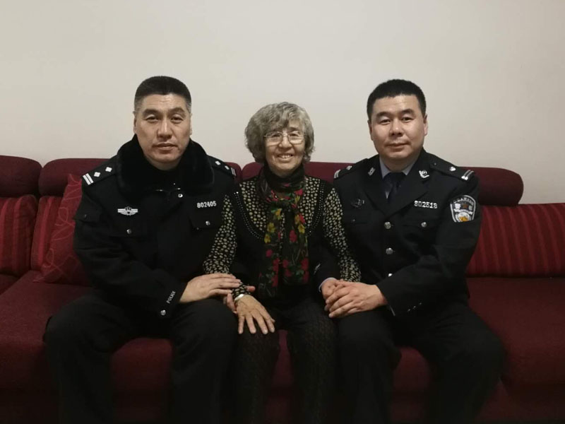 警察儿子李凯、李浩牵着母亲王桂芝的手留影