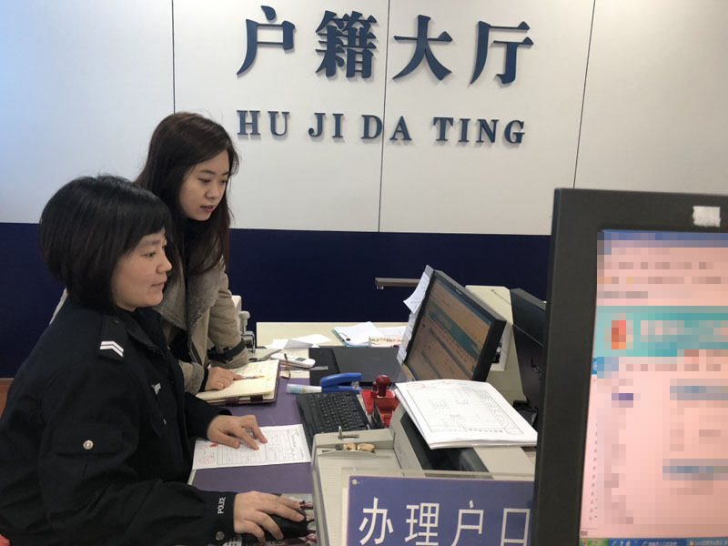 图五 户籍大厅办事民警在教记者如何登记户口