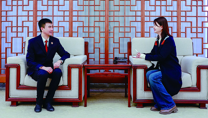 李冠山（左）接受记者采访