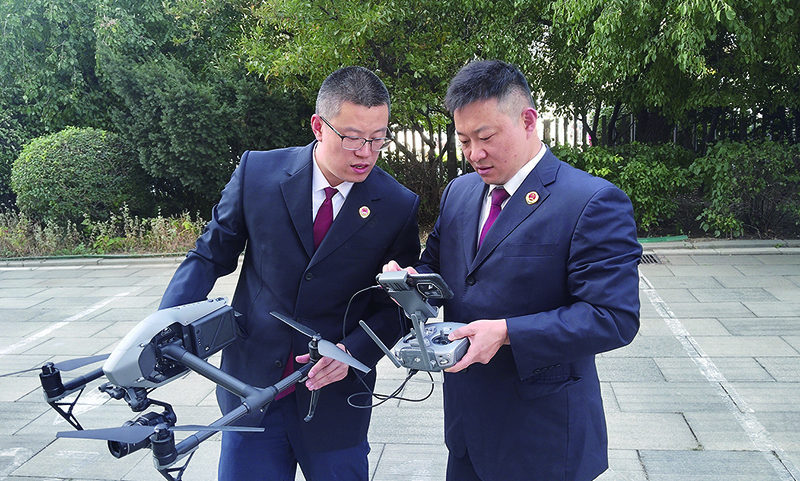 无人机驾驶员关毅(左)刘晓晨(右)在研讨制定无人机飞行路线