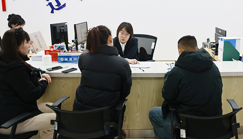 省公共法律服务中心公证窗口工作人员在回答群众咨询