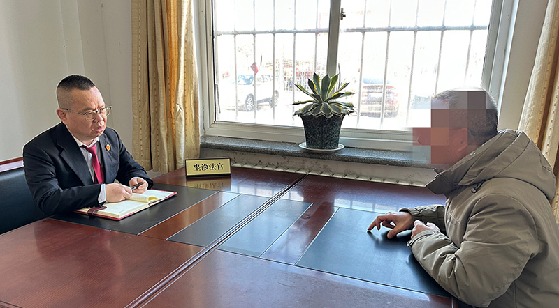 赵建峰（左一）在“法律诊室”为前来咨询的群众解答法律问题。